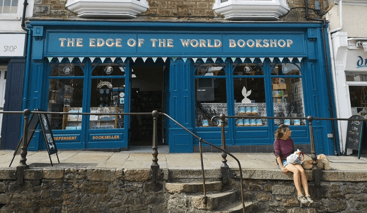 The blue shopfront of The Edge of the World Bookshop on the Land's End Round walking holiday